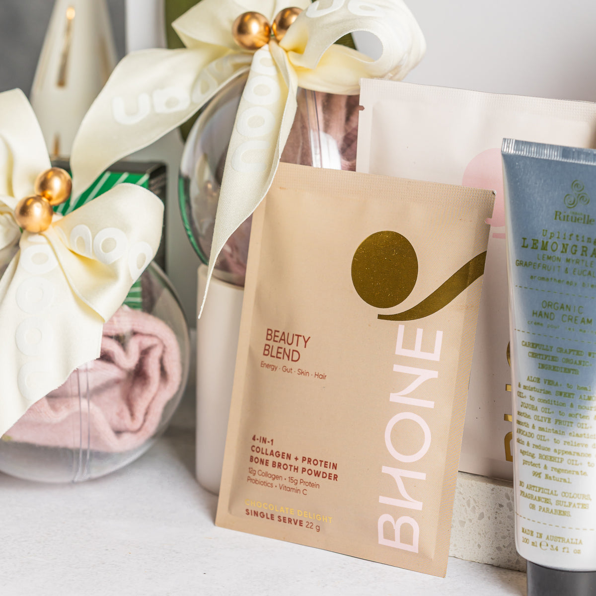 BHONE Beauty Blend sachet beside lemongrass hand cream and clear baubles with Nooan Socks tied with ivory ribbon