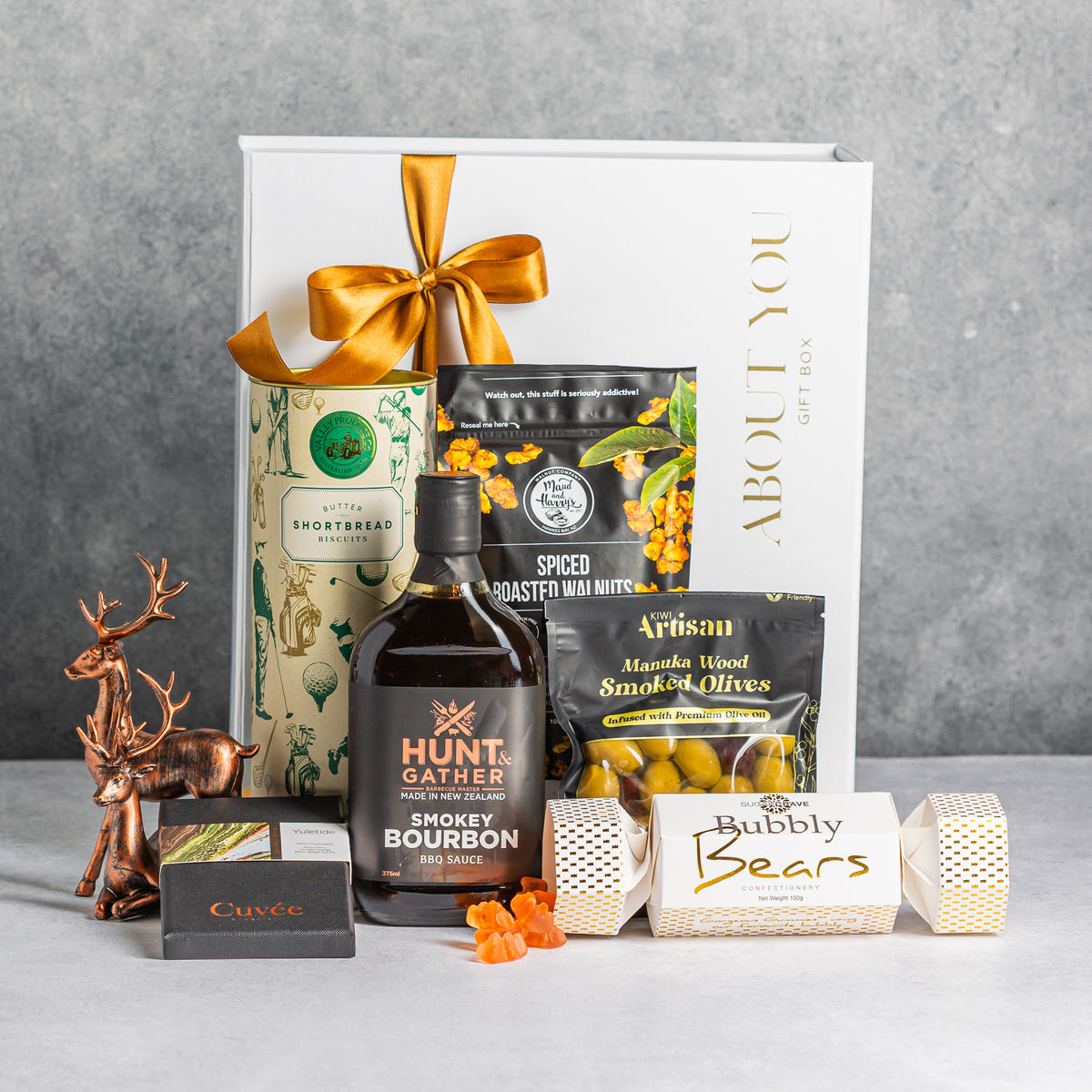 Christmas gift box with smoky bourbon BBQ sauce, golf-themed shortbread tin, smoked olives, spiced walnuts and sweet treats