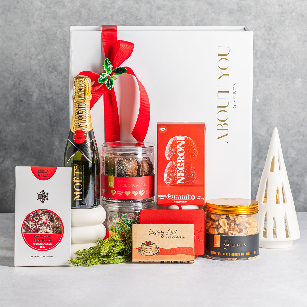 Christmas gift box with mini Moët champagne, festive chocolates, Negroni gummies, salted nuts and Getting Lost Christmas Edition