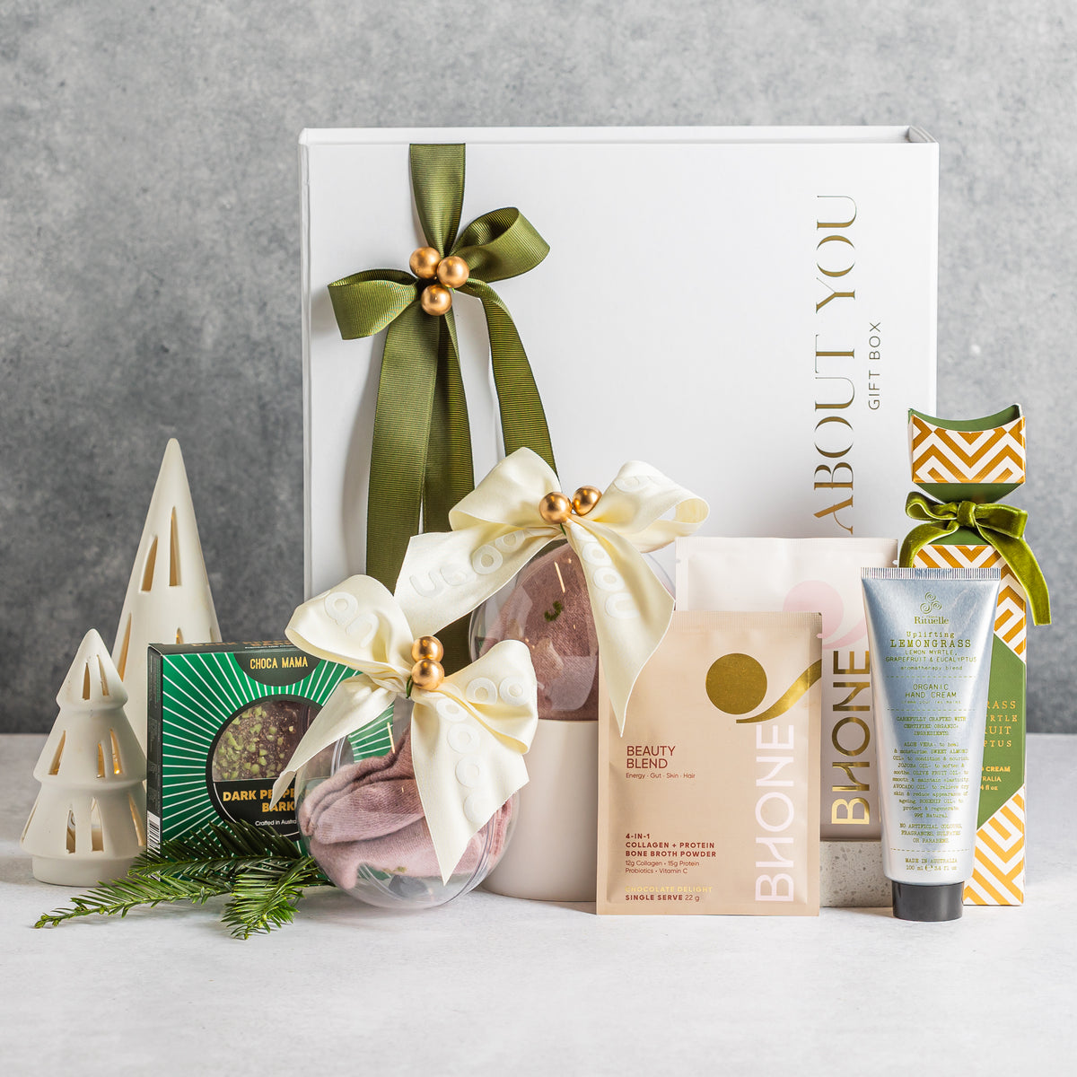 Christmas pamper gift box with ribbon-tied clear baubles, peppermint bark, lemongrass hand cream and a Beauty Blend sachet Nooan Socks