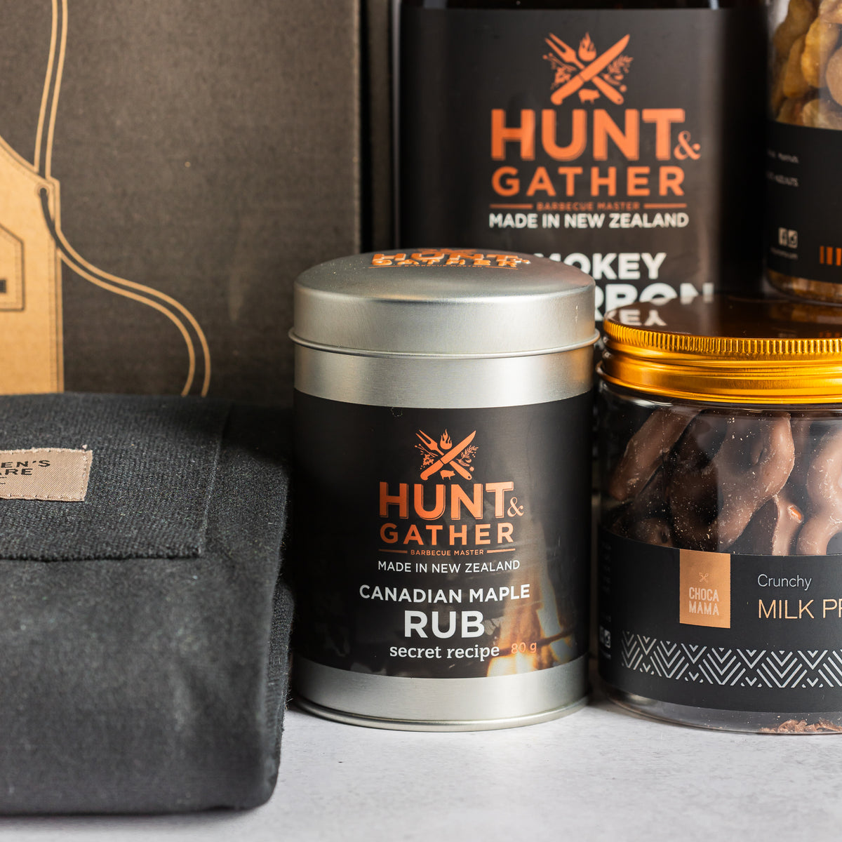 New Zealand-made Hunt & Gather Canadian maple BBQ rub beside smoky bourbon sauce and chocolate-coated pretzels